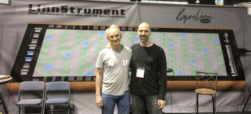 Roger Linn and Geert Bevin in front of a giant LinnStrument banner